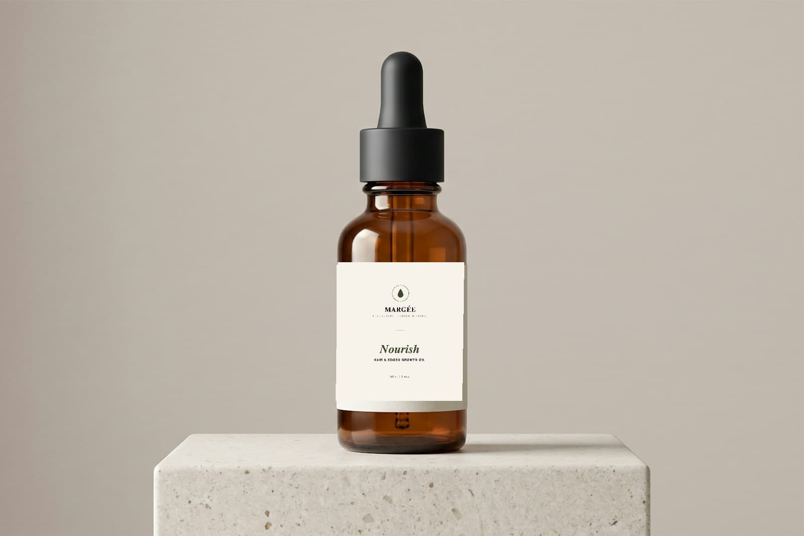 MARGÉE Nourish Hair & Edges Growth Oil, amber glass dropper bottle on a stone pedestal